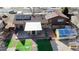 Aerial view of updated backyard with patio, synthetic grass, and unique structures for creative storage at 860 S 7Th Ave, Brighton, CO 80601