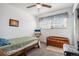 This cozy bedroom has a ceiling fan, a window, and a neutral color scheme at 860 S 7Th Ave, Brighton, CO 80601