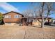 Charming split-level home with a wood and brick exterior and inviting front porch at 860 S 7Th Ave, Brighton, CO 80601