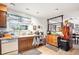 Kitchen area with wood cabinets, tile flooring, and a large sink with window, cozy design at 860 S 7Th Ave, Brighton, CO 80601