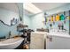 This is a laundry room with a sink and side by side washer and dryer at 860 S 7Th Ave, Brighton, CO 80601