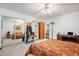 The primary bedroom includes mirrored closet doors, a ceiling fan, and an ensuite bathroom at 860 S 7Th Ave, Brighton, CO 80601