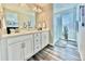 Main bathroom with double vanity, a large shower, and wood-look tile floor at 3734 Makley Cir, Castle Rock, CO 80104