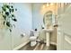 Stylish powder room with pedestal sink and wood-look flooring at 3734 Makley Cir, Castle Rock, CO 80104