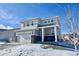 Two-story house with gray siding, stone accents, and a two-car garage at 3734 Makley Cir, Castle Rock, CO 80104