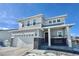 Two-story house with gray siding, stone accents, and a two-car garage at 3734 Makley Cir, Castle Rock, CO 80104