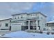 Two-story house with gray siding, stone accents, and a two-car garage at 3734 Makley Cir, Castle Rock, CO 80104