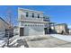 Two-story house with gray siding, stone accents, and a two-car garage at 3734 Makley Cir, Castle Rock, CO 80104