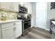 Kitchen with white cabinets and stainless steel appliances at 3734 Makley Cir, Castle Rock, CO 80104