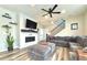 Living room with L-shaped sofa, fireplace, and large TV at 3734 Makley Cir, Castle Rock, CO 80104