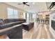 Open living room featuring hardwood floors, modern sectional sofa, and kitchen with island at 3734 Makley Cir, Castle Rock, CO 80104