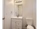 Bathroom with a white vanity, silver faucet, lighting, and a toilet at 1922 S Oswego Way, Aurora, CO 80014