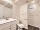 Bathroom featuring new vanity with modern faucet, toilet, and walk-in shower at 1922 S Oswego Way, Aurora, CO 80014