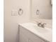 Close up of a bathroom sink with a silver faucet, white vanity, and a mirror above at 1922 S Oswego Way, Aurora, CO 80014