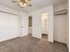 Bedroom with neutral carpet, ceiling fan, white walls, a bathroom, and a closet at 1922 S Oswego Way, Aurora, CO 80014