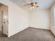 Bedroom with neutral carpet, ceiling fan, white walls, and a window with blinds at 1922 S Oswego Way, Aurora, CO 80014