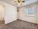 A neutral bedroom features a ceiling fan, carpet, and a window with natural light at 1922 S Oswego Way, Aurora, CO 80014