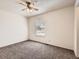 Bedroom with neutral carpet, ceiling fan, white walls, and a window with blinds at 1922 S Oswego Way, Aurora, CO 80014