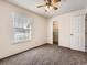 Bright bedroom with a window, carpet flooring, and a ceiling fan for added comfort at 1922 S Oswego Way, Aurora, CO 80014