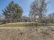 View of the community's grounds with mature trees and a black metal fence at 1922 S Oswego Way, Aurora, CO 80014