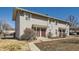 A daytime exterior view of a multi-Gathering home with light colored siding and red doors at 1922 S Oswego Way, Aurora, CO 80014