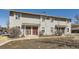 Traditional home with neutral siding, trimmed windows and covered entryways, landscaped with grass and mulch at 1922 S Oswego Way, Aurora, CO 80014