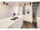 Bright kitchen featuring an island, stainless steel sink, modern appliances, and dark wood flooring at 1922 S Oswego Way, Aurora, CO 80014