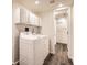 Well-lit laundry room features a washer and dryer, and plenty of storage space at 1922 S Oswego Way, Aurora, CO 80014