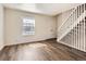 Spacious living room featuring modern flooring, bright natural light, white walls and staircase at 1922 S Oswego Way, Aurora, CO 80014