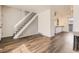 Open floor plan showcasing wood floors, stairs, and seamless flow into kitchen at 1922 S Oswego Way, Aurora, CO 80014