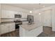 Modern kitchen with white cabinets, granite counters, and stainless steel appliances at 27500 E Cedar Pl, Aurora, CO 80018