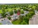 Aerial view of townhomes surrounded by lush greenery, a pond, and a golf course at 2650 S Vaughn Way # B, Aurora, CO 80014