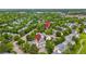 Aerial view of homes in a green, tree-filled neighborhood, highlighting the pool and surrounding landscape at 2650 S Vaughn Way # B, Aurora, CO 80014