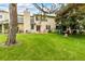 Sprawling backyard with green lawn, mature trees, and a patio area for outdoor entertaining at 2650 S Vaughn Way # B, Aurora, CO 80014