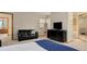 Bedroom featuring a dark loveseat, a dresser, and a mirror at 2650 S Vaughn Way # B, Aurora, CO 80014