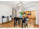 Eat-in kitchen with hardwood floors, modern lighting, and stainless steel appliances in the background at 2650 S Vaughn Way # B, Aurora, CO 80014