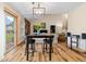 Dining area featuring a modern light fixture, wood flooring, and a view to the living room at 2650 S Vaughn Way # B, Aurora, CO 80014