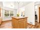Modern kitchen island with ample counter space, stylish pendants, and bright natural light at 2650 S Vaughn Way # B, Aurora, CO 80014