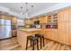 Bright kitchen boasts stainless steel appliances, a center island, and warm wood cabinets at 2650 S Vaughn Way # B, Aurora, CO 80014