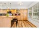 Well-lit kitchen offers ample cabinet space, a central island, and contemporary light fixtures at 2650 S Vaughn Way # B, Aurora, CO 80014