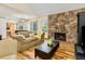 Cozy living room featuring a stone fireplace, hardwood floors, and comfortable seating at 2650 S Vaughn Way # B, Aurora, CO 80014