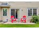 Outdoor patio area with two red Adirondack chairs, perfect for relaxation and outdoor dining at 2650 S Vaughn Way # B, Aurora, CO 80014