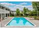 Community pool with lounge chairs and a well-maintained fence and landscaping at 2650 S Vaughn Way # B, Aurora, CO 80014