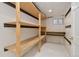 Unfinished storage area with bright lighting and wood shelving at 2650 S Vaughn Way # B, Aurora, CO 80014