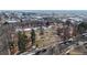 Aerial view of neighborhood park with walking paths, trees, and nearby buildings and wintery foliage at 108 W Byers Pl # G4, Denver, CO 80223