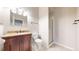 Bathroom featuring granite vanity, bowl sink, framed mirror, and tiled floor at 108 W Byers Pl # G4, Denver, CO 80223