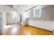 This bedroom features hardwood floors, arched doorway, and natural light from two windows at 108 W Byers Pl # G4, Denver, CO 80223