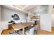 Dining area with a large table, modern chairs, and view into the kitchen at 108 W Byers Pl # G4, Denver, CO 80223