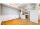 Open-concept dining area with hardwood floors, white walls, and kitchen view at 108 W Byers Pl # G4, Denver, CO 80223