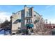 Exterior building entrance with blue awnings and a vintage architectural style at 108 W Byers Pl # G4, Denver, CO 80223